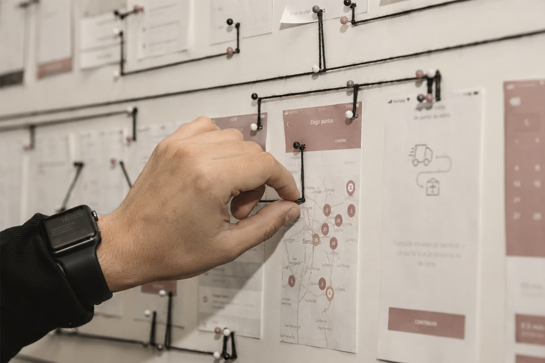 Hands arranging a spatial strategy journey map